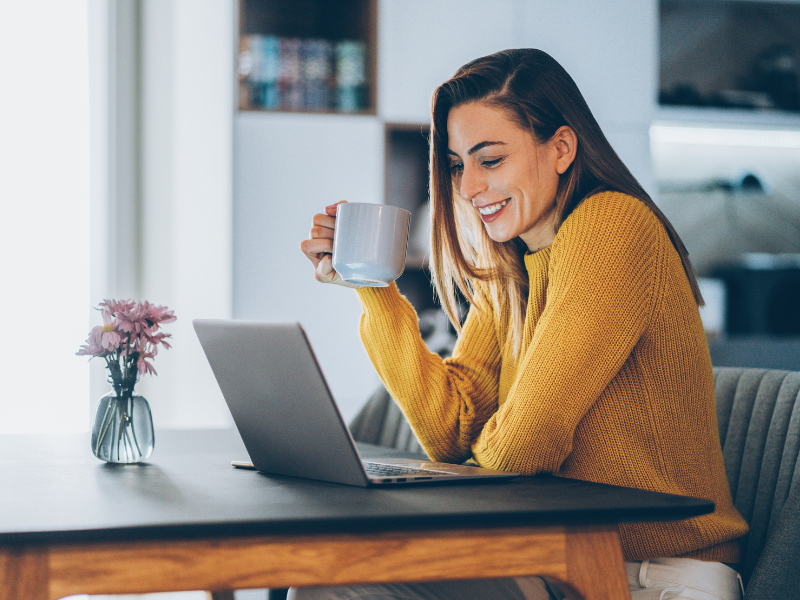 travel business ideas - woman using her laptop to work in the travel industry in her home office