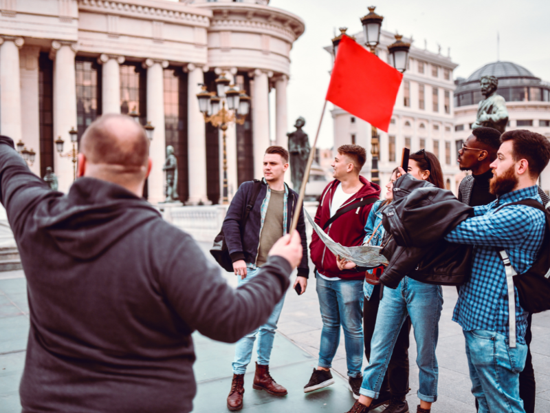 travel business ideas - tour guide showing customers the sights